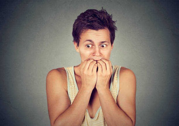 istock Portrait anxious young man biting his nails fingers freaking out 668409012