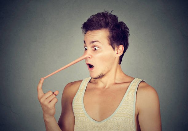 istock Man with long nose isolated on grey wall background. Liar concept 668409152
