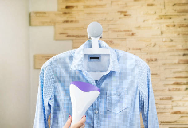Ironing a shirt with a clothes steamer