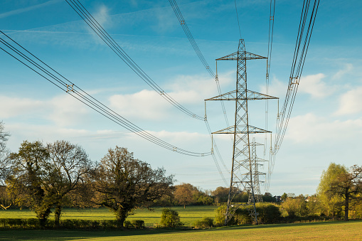 An image of electricity lines carrying power across the countryside of Leicestershire, England, UK