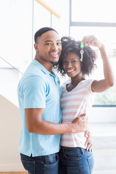 istock Young couple showing their house key 668422274