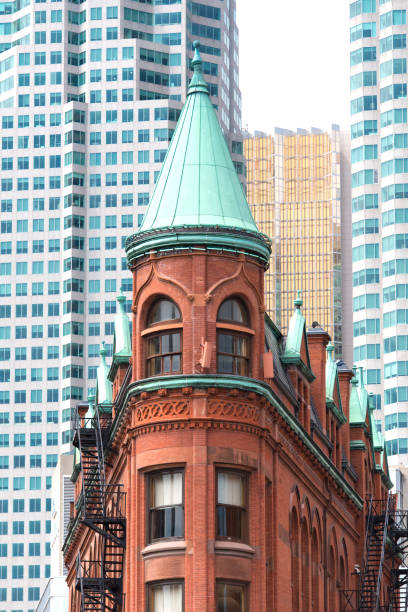 Gooderham Building or Flatiron building Gooderham Building or Flatiron building with modern skyscrapers in background in the historic center of Toronto. flatiron building toronto stock pictures, royalty-free photos & images