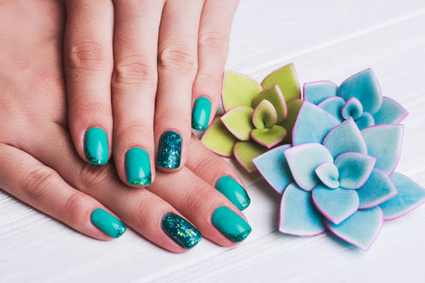 istock Turquoise nail art with tinsels 668422766