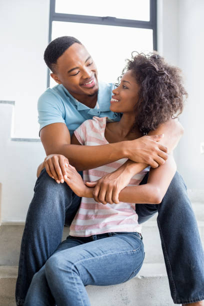 istock Young couple looking at each other and embracing 668423098