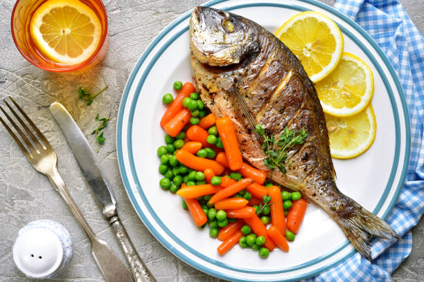 istock Baked dorado or sea bream with spring vegetables 668423166