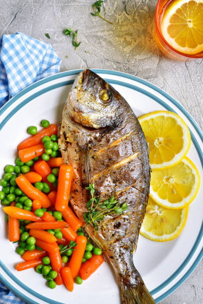 istock Baked dorado or sea bream with spring vegetables 668423176