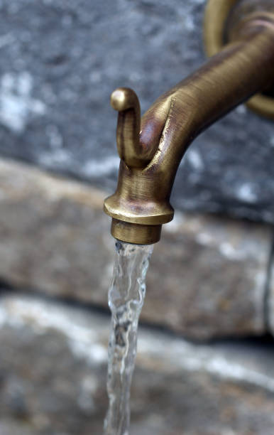 istock The bronze tap with flowing water 668431070