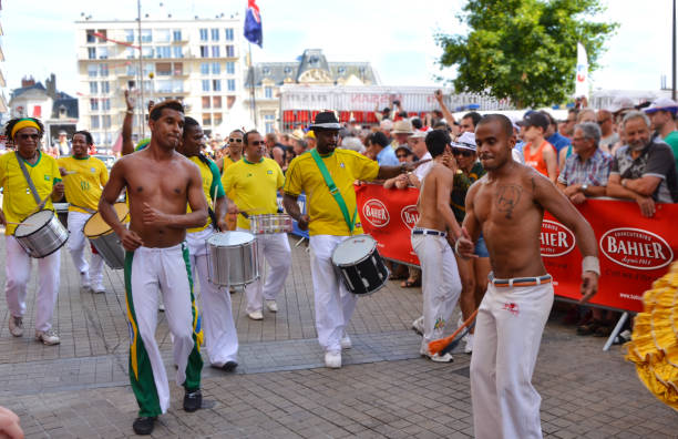 LE MANS, FRANCE - JUNE 13, 2014: Brazilian man dancing at a parade of pilots racing. LE MANS, FRANCE - JUNE 13, 2014: Brazilian man dancing at a parade of pilots racing in Le mans,France. belle isle stock pictures, royalty-free photos & images