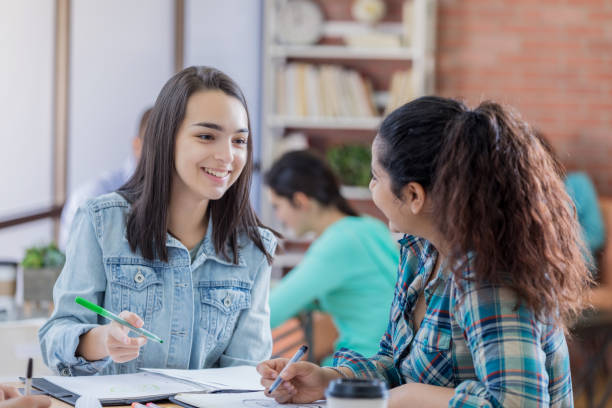 istock College friends study together in student center 668442642