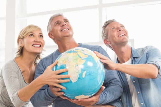 istock Happy business colleagues holding terrestrial globe 668446274