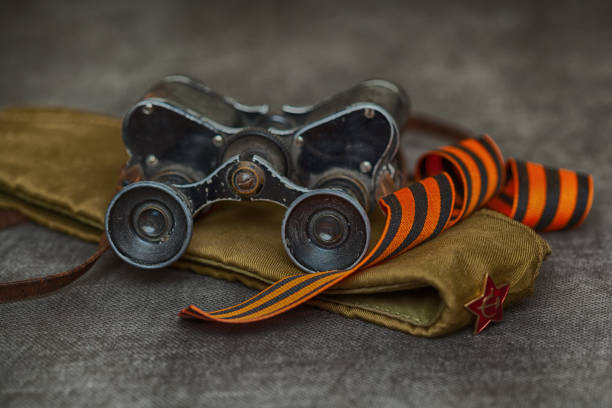 military binoculars, soldier field cap, george ribbon. still life for the victory day - may 9 - 1941 imagens e fotografias de stock