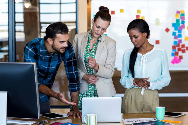 istock Young man and women discuss using laptop 668449798
