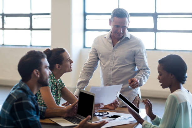istock Young man and women sitting at their desk 668450620