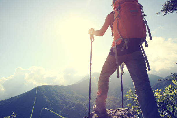 istock young woman hiker hiking on mountain peak 668453364