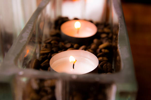 2 warm peaceful candles setting a good mood in a glass vase. Taken on the island of Bornholm.