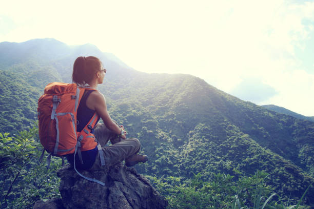 istock successful young woman hiker hiking on mountain peak 668459658