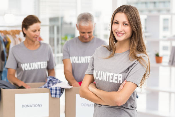 istock Smiling female volunteer with arms crossed 668463394