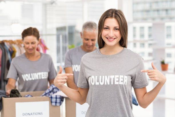 istock Smiling female volunteer pointing on shirt 668463416