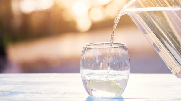 Pouring Water From Pitcher Into Glass