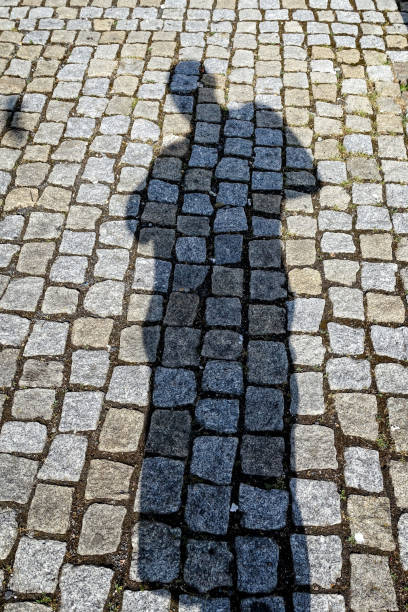 istock Human shadow on the pavement on a sunny day. 668466530