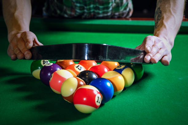 istock The player's hands hold the billiard triangle 668470076