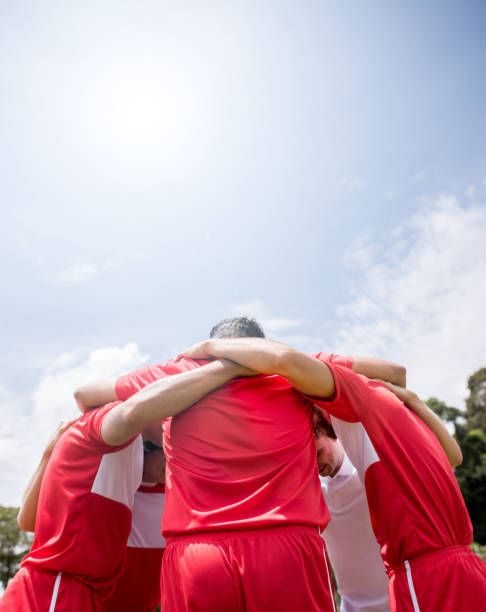 istock Soccer players hugging and discussing tactics 668472336