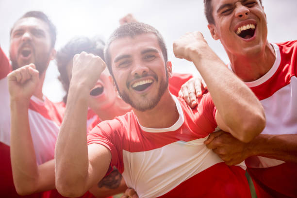 istock Excited soccer team celebrating a goal 668472408