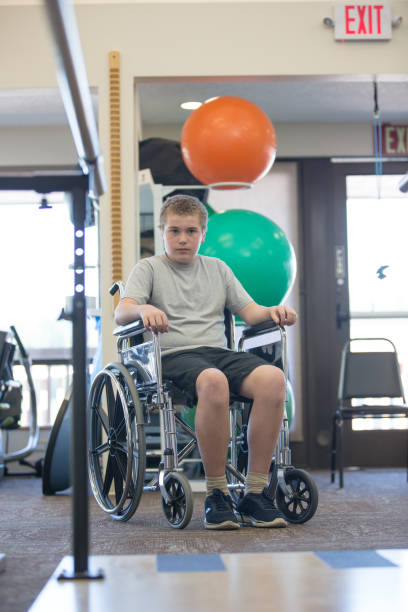 istock Young boy in wheelchair waits to begin physical therapy 668472502
