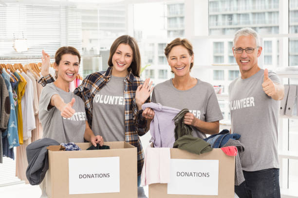 istock Smiling volunteers with donation boxes 668474146
