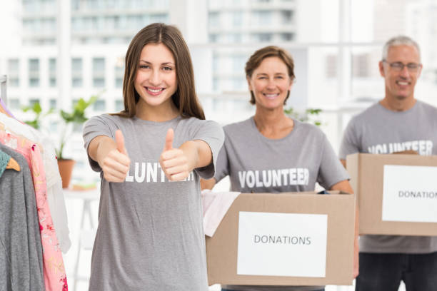 istock Smiling volunteers holding donation boxes 668476852