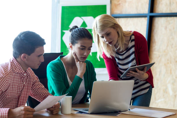 istock Colleague discussing with at desk 668480540