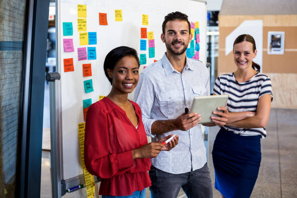 istock Colleagues standing in front of the white board 668480652
