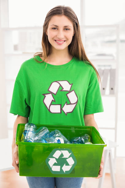 istock Smiling eco-minded brunette holding recycling box 668487092