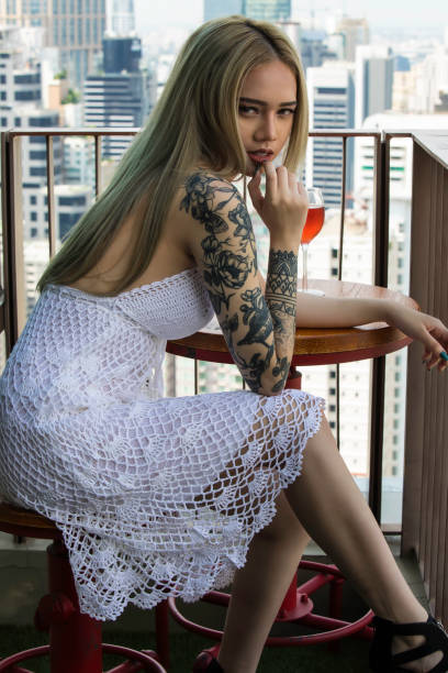 Woman posing on a balcony in Bangkok.