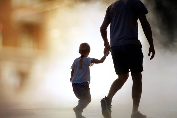 man runing / rescue wiith child from fire stock photo