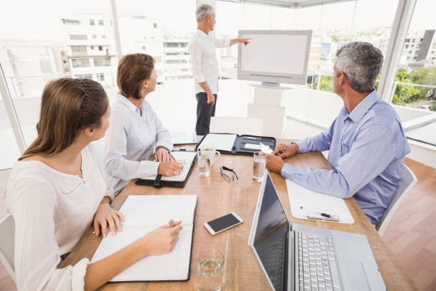 istock Business people listening to colleagues presentation 668503502