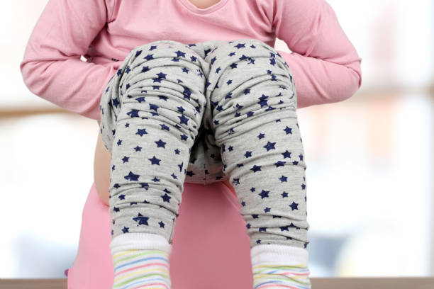 istock Children's legs hanging down from a chamber-pot on a blue background 668509890
