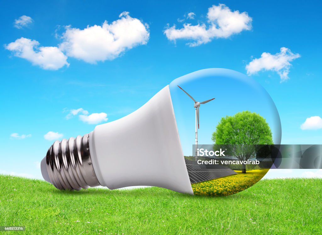 Eco LED light bulb with solar panel and wind turbine. Eco LED light bulb with solar panel and wind turbine. The concept of sustainable resources. LED Light Stock Photo