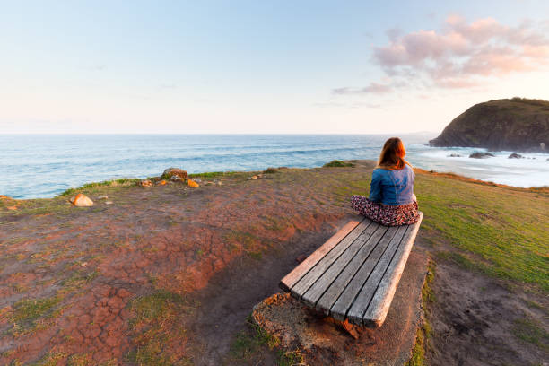 Young Woman Looks Over Morning Ocean View stock photo