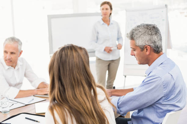 istock Business people listening to presentation 668519404