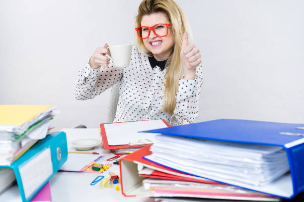 istock Happy woman at office drinking hot coffee 668519788