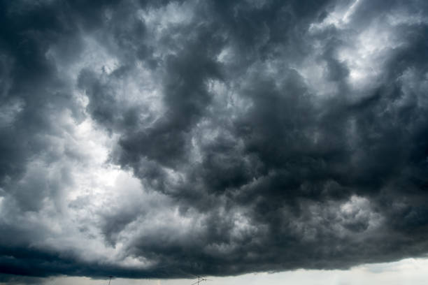 istock Background of dark clouds before a thunder-storm ,sunlight through very dark clouds background ,White Hole in the Whirlwind of dark storm clouds 668519944