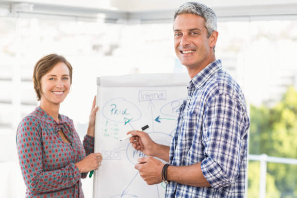 istock Casual business colleagues preparing presentation 668519958