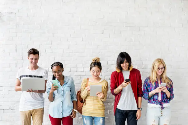 Photo of Diversity Friends Using Digital Devices Concept