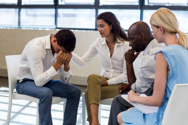istock Colleagues comforting a unhappy man 668523390
