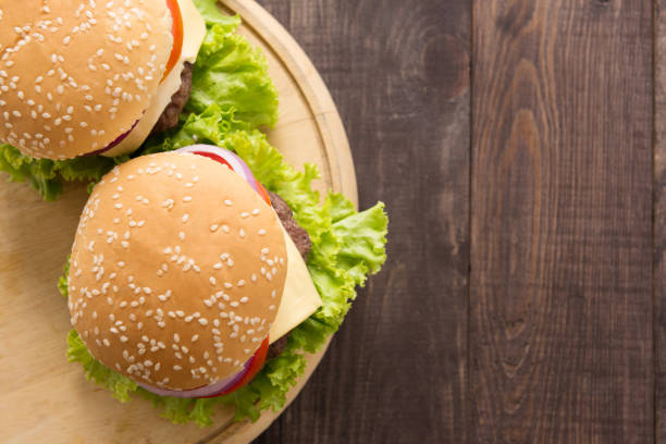istock Top view bbq hamburger on the wooden background 668523646