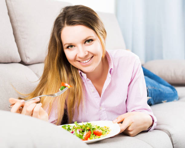 istock Woman tasting fresh green salad 668536428