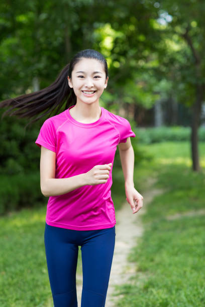 istock young beautiful jogger running in nature 668537320