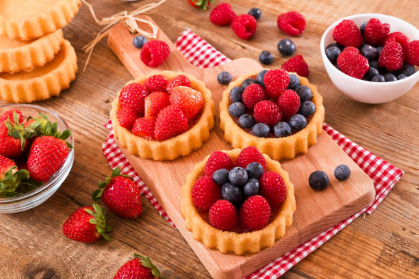 istock Tartlets with forest fruits. 668537328