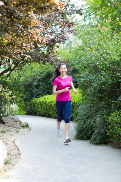 istock young beautiful jogger running in nature 668537868